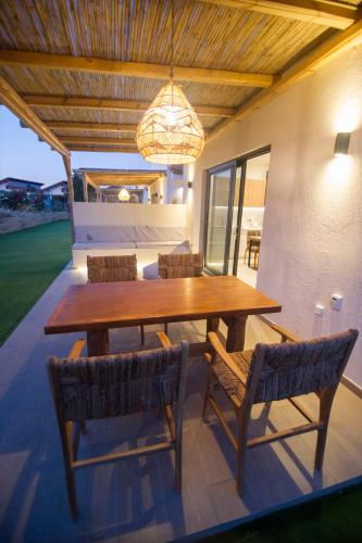 a dining room with a wooden table and chairs at Kalliopi Luxury Apartments in Kalliópi