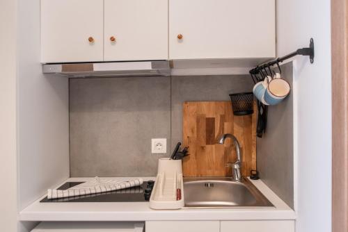 a kitchen with a sink and a counter top at Olesia Rooms in Naousa in Naousa