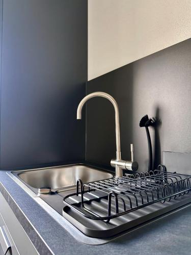 a kitchen counter with a sink and a stove at Moderne Ferienwohnung in Jettingen-Scheppach