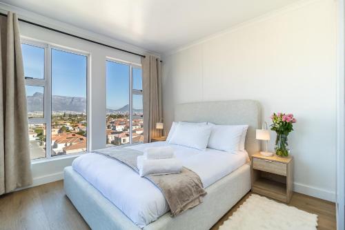 a bedroom with a bed with a large window at 2 Bedroom, Mountain View Penthouse, Century City in Cape Town
