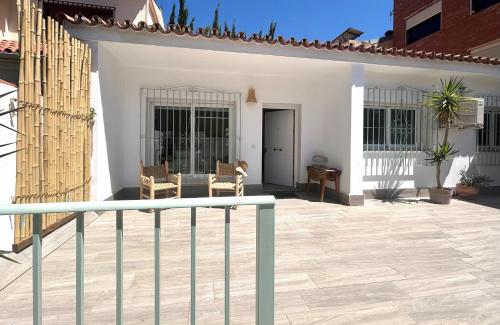 a white house with a fence and a patio at La Brisca Sun & Soul Pedregalejo in Málaga