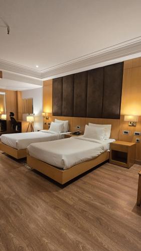 a hotel room with two beds in a room at Hotel Shemron 