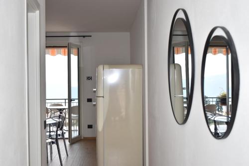 a bathroom with two mirrors on a wall at Residence Mirabel in Tignale