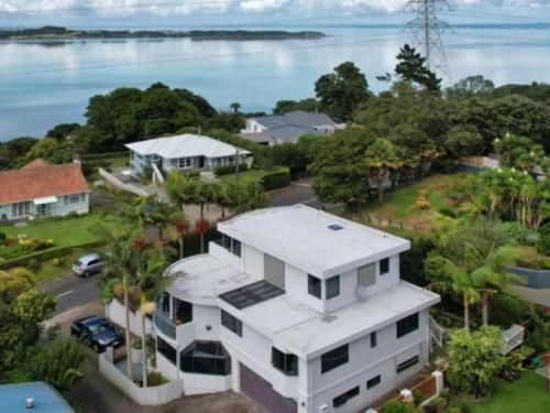 an aerial view of a house with the ocean in the background at Tranquil Haven Retreat in Auckland