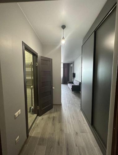 an empty hallway with a door and a room with a bed at Pirosmani Mini Hotel in Batumi