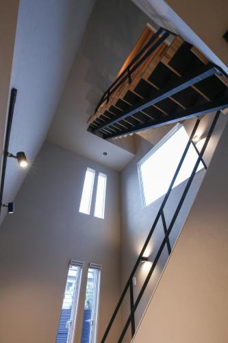 a loft bed in a room with two windows at 62 Fuji Petel DEUX -ドゥ- in Fujikawaguchiko