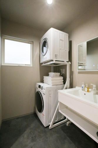 a laundry room with a washing machine and a sink at 62 Fuji Petel DEUX -ドゥ- in Fujikawaguchiko