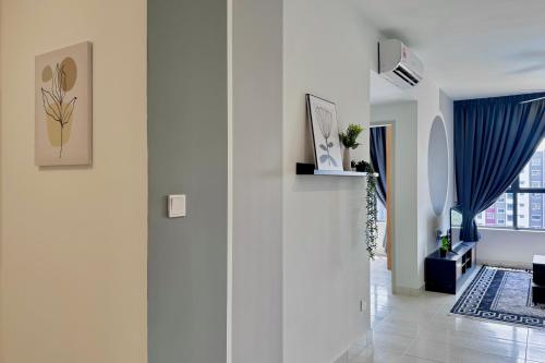 a hallway with white walls and a blue curtain at Alanis Suite With Netflix @ KLIA Sepang in Sepang