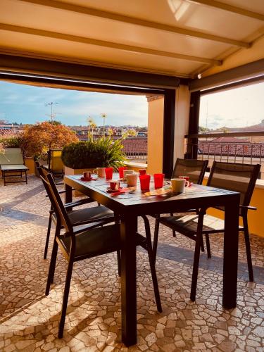 a table and chairs on a patio with a view at Maison Mavino in Desenzano del Garda