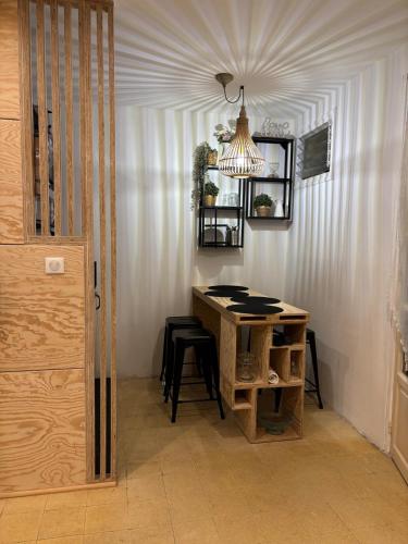 a room with a table and chairs and a chandelier at Eden Studio in Ajaccio