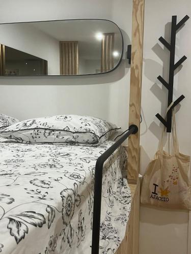 a bedroom with a bed and a mirror at Eden Studio in Ajaccio