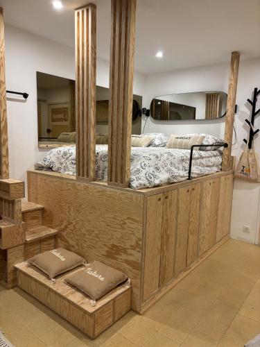 a bedroom with a large wooden bed with two mattresses at Eden Studio in Ajaccio
