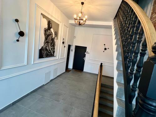 a staircase in a house with a chandelier at Apartament Frombork Łempicka in Frombork
