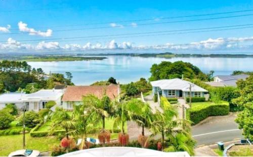 a house with a view of a lake at Tranquil Haven Retreat in Auckland