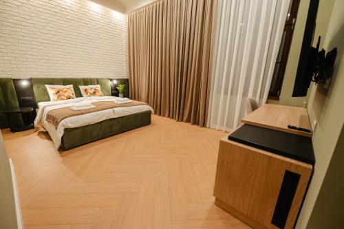 a hotel room with a bed and a television at Villa Botar in Cluj-Napoca