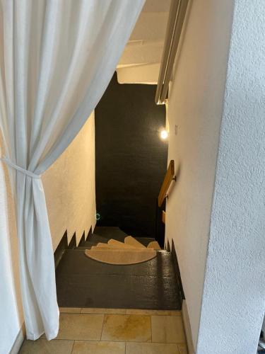 a stairway with a curtain next to a room at Sweet Home in Murten