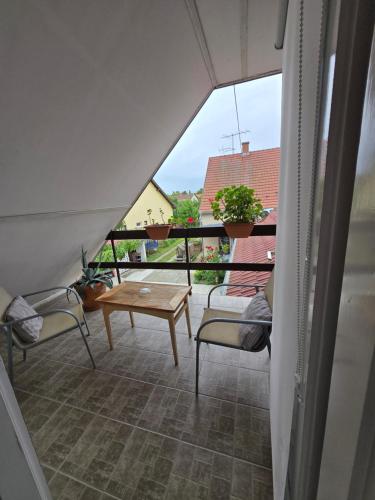 a view of a balcony with chairs and a table at Sára Vendégház in Szentes