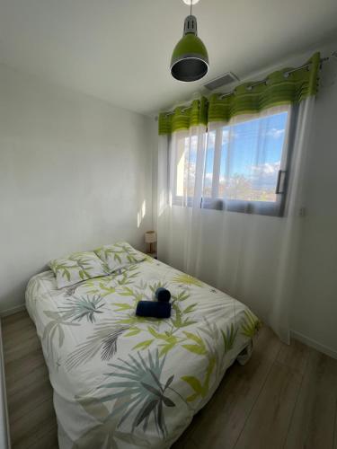 a bedroom with a bed with a cat laying on it at Grande villa avec piscine et spa in Longages