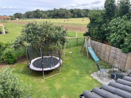 an aerial view of a playground with a trampoline at Grande villa avec piscine et spa in Longages