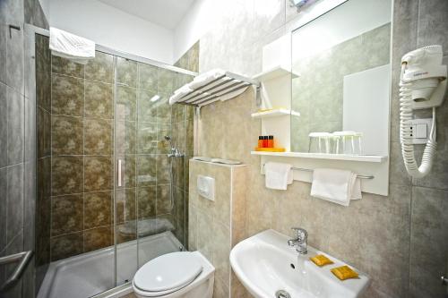 a bathroom with a toilet and a shower and a sink at Valenti rooms in Split