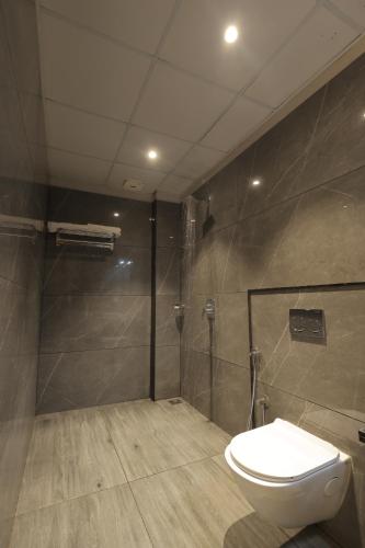a bathroom with a toilet and a shower at Balaji Seven Hills in Jaipur