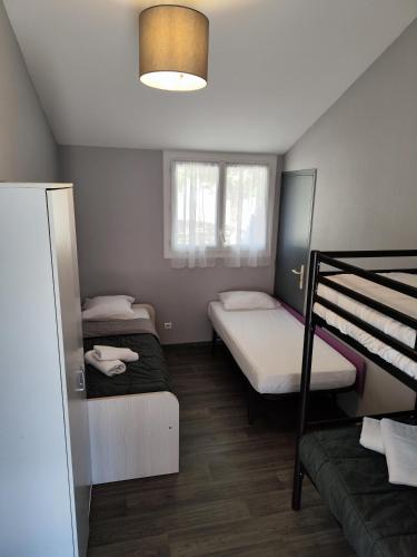 a room with two bunk beds and a couch at Aux Portes des Monts d'Aubrac in Espalion