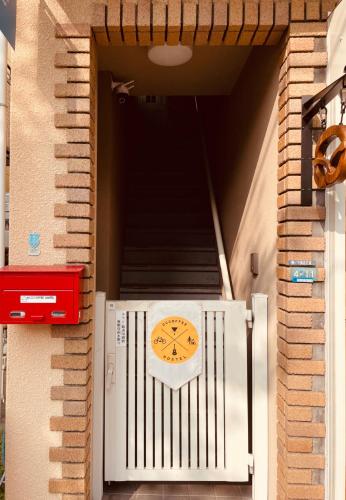 a clock on the side of a building at CCCOFFEE HOSTEL Kobe in Kobe