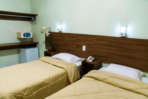 a bedroom with two beds and a head board at Belém Soft Hotel in Belém