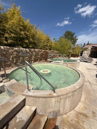 a hot tub in a stone wall with at Casale Terre Rosse in Saturnia