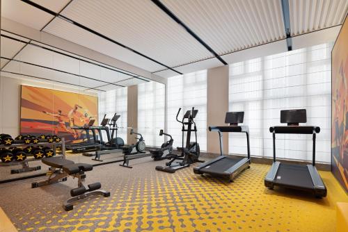 a gym with several treadmills and exercise bikes at Hampton By Hilton Dongguan Nancheng Xiping in Baima