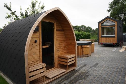 a large wooden iguana house with a grill at my-tinyhouse in Neuendorf-Sachsenbande