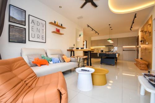 a living room with a couch and a kitchen at Country Garden Seaview Suite by Nest Home at Danga Bay in Johor Bahru