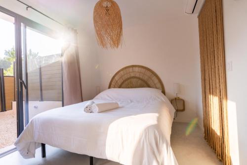 a bedroom with a white bed and a large window at Villa le Jas de Bali - 4chambres - Piscine et parking privé in Figanières