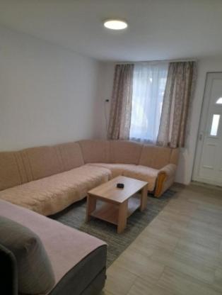 a living room with a couch and a coffee table at Apartment Victoria in Foča