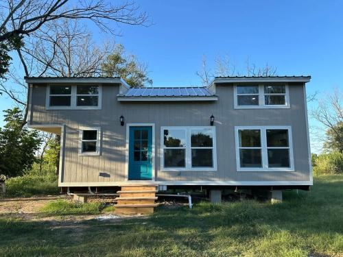 a tiny house with a green door and windows at Tiny Private Room #3 in Shared 5BR House with Other Guests in Austin