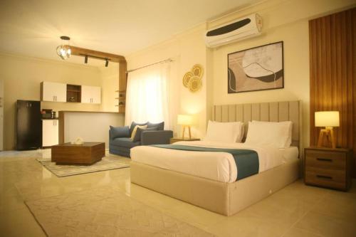 a bedroom with a bed and a living room at Settle Inn South 90 Apartments in Cairo