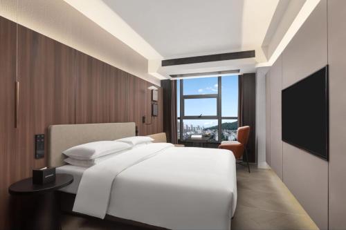 Ένα ή περισσότερα κρεβάτια σε δωμάτιο στο Days Hotel by Wyndham Zhuzhou Liling