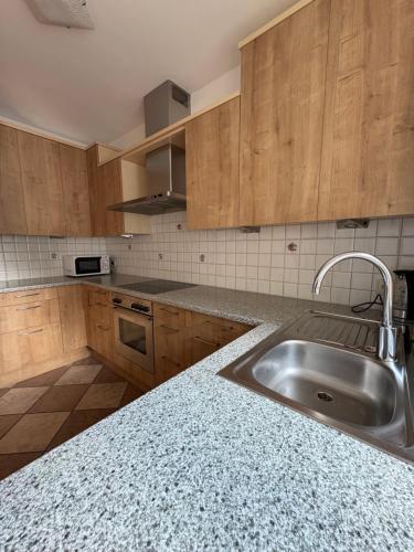 a kitchen with a stainless steel sink and wooden cabinets at Apartment Apfel in Naturno