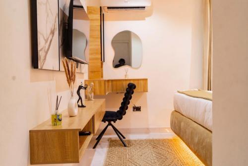 a living room with a desk and a bed at Luxury 2 Bedroom Apartment, Located in Admiralty way, Lekki Phase 1 in Lagos