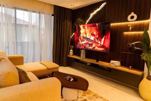 a living room with a tv with a fire on it at Luxury 2 Bedroom Apartment, Located in Admiralty way, Lekki Phase 1 in Lagos