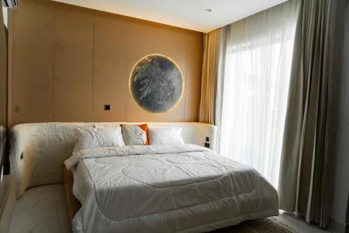 a bedroom with a large bed and a window at Luxury 2 Bedroom Apartment, Located in Admiralty way, Lekki Phase 1 in Lagos