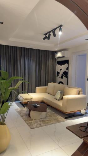 a living room with a couch and a table at Luxury 2 Bedroom Apartment, Located in Admiralty way, Lekki Phase 1 in Lagos