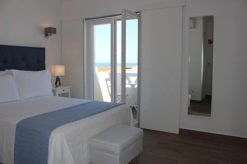 a bedroom with a bed and a view of the ocean at River Inn - Duna Parque Group in Vila Nova de Milfontes