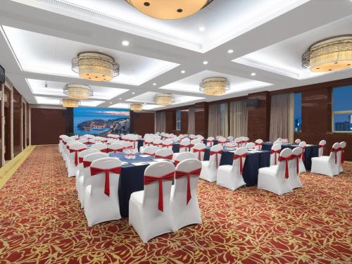 a banquet hall with tables and chairs in a room at Days Hotel & Suites China Town---Five minutes to reach Changsha Station, the metro Line 2 & Line 6 are nearby,free gym & laundromat,Chinese and Western buffet breakfast is offered on the 31st floor in Changsha