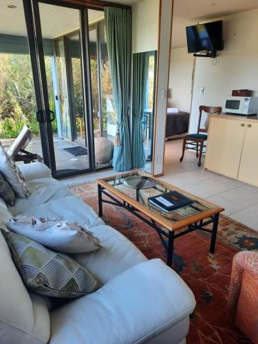 a living room with a couch and a coffee table at Titore Lodge in Russell