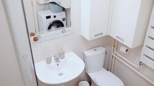 a small bathroom with a toilet and a sink at Apartment SOFI Belville in Novi Beograd