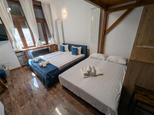 a bedroom with two beds with towels on them at Ultra-central apartment in the Dauerbach Palace in Timişoara