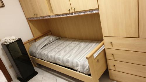 a small bedroom with a bed and a dresser at Ca da Simo in Albenga