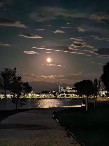 a full moon over a body of water at night at Istrabella Apartment in Koper