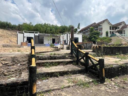a fence with some stairs in front of a house at CasaView Island Marang in Marang